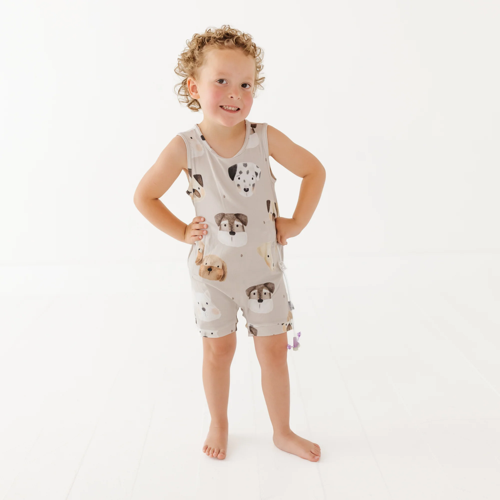 Boy wears dog patterned toddler romper
